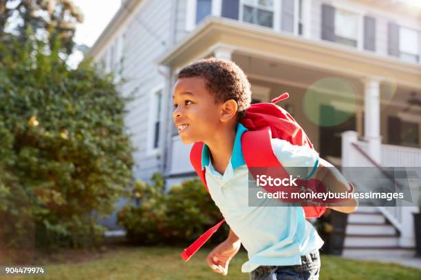 Young Boy Leaving House To Walk To School Stock Photo - Download Image Now - Child, Backpack, Education