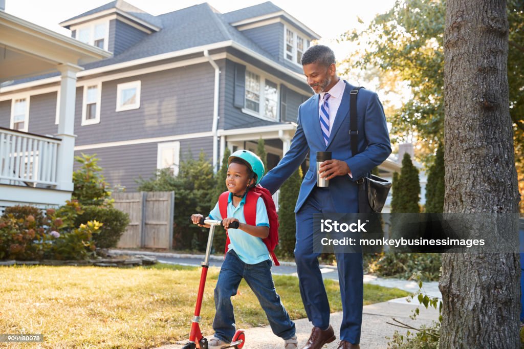 Businessman Father Walking Son On Scooter To School Child Stock Photo