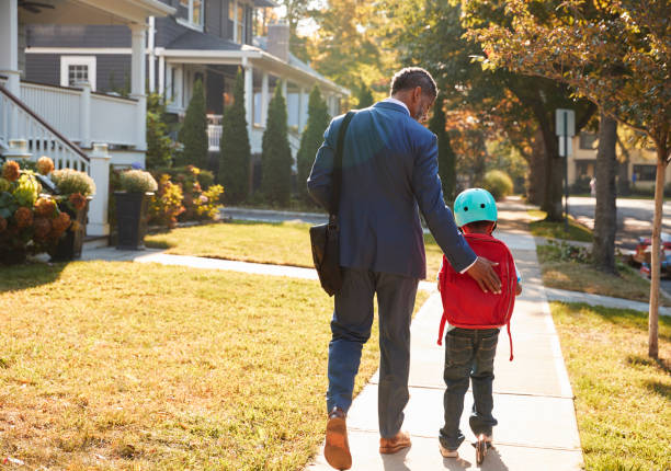 istock Businessman Father Walking Son On Scooter To School 904480116