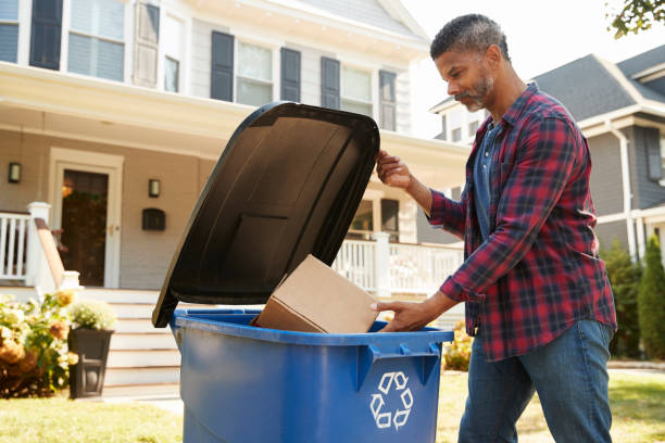 Man Filling Recycling Bin On Suburban Street Man Filling Recycling Bin On Suburban Street recycling bin photos stock pictures, royalty-free photos & images