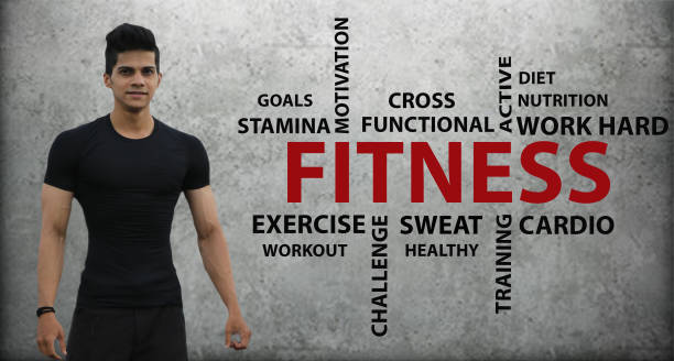 Muscular man with fitness word cloud concept on wall