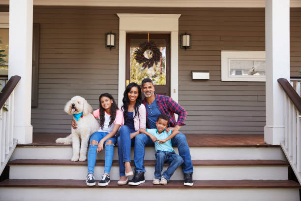 family with children and pet dog sit on steps of home - family portrait imagens e fotografias de stock