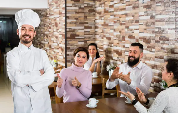 Photo of Happy chef listens to praise of the food