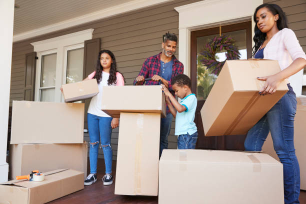 istock Children Helping Children With Boxes On Moving In Day 904483688