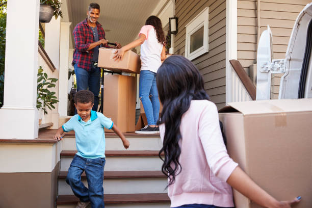 istock Children Helping Children With Boxes On Moving In Day 904483692