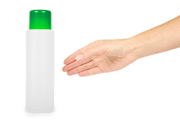 istock Plastic white shampoo bottle with blue cap in hand isolated on white background. Gel dispenser for hair care. Container with body lotion. 904483706