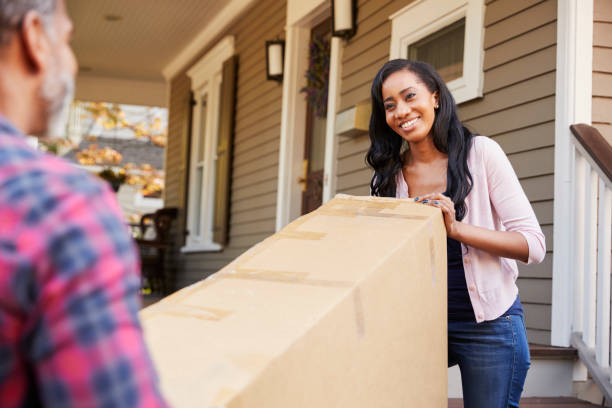 istock Couple Carrying Big Box Purchase Into House 904483876