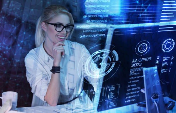 istock Happy programmer looking at the transparent screen of a computer and smiling 904483886