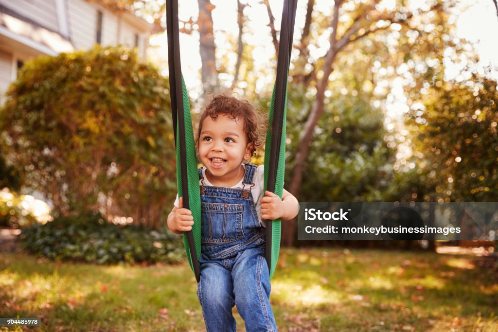 Happy Young Girl Playing On Garden Swing 2-3 Years Stock Photo