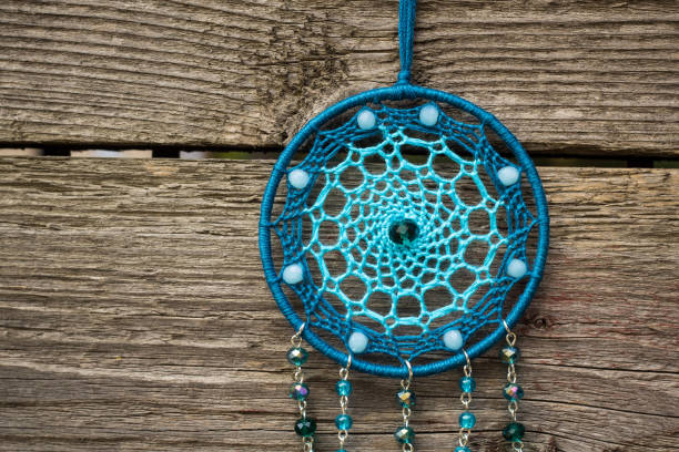 istock Handmade dream catcher with feathers threads and beads rope hanging 904487554