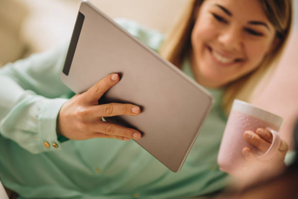 istock Close up of a woman using digital tablet during coffee time. 904487632