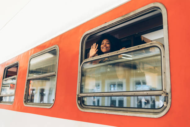 istock Woman waving hand through train window 904493530