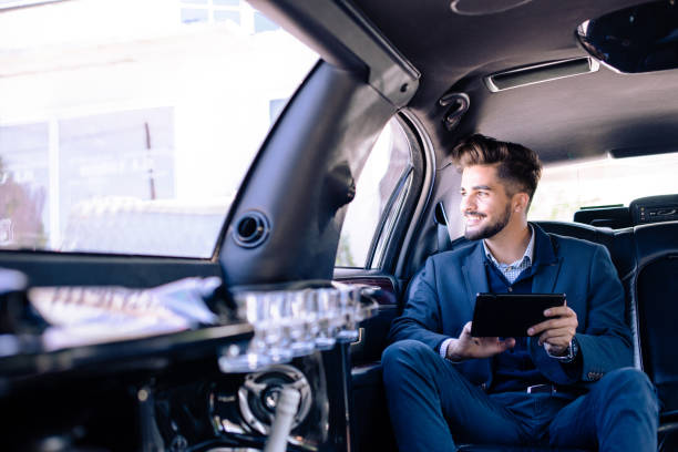 Young businessman sitting in limo