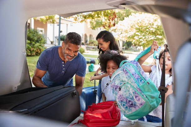 istock Family Leaving For Vacation Loading Luggage Into Car 904503244