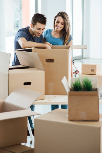 istock Smiling couple moving in a new house 904503416
