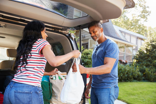 istock Couple Unloading Shopping Bags From Car 904505980