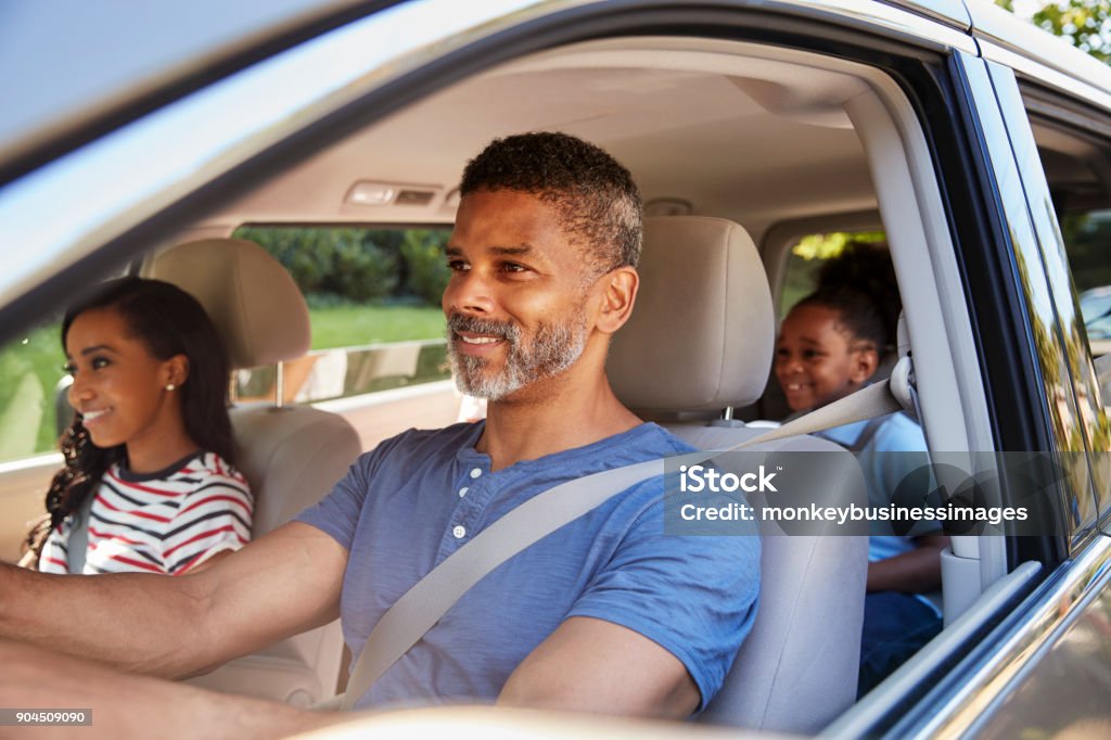 Family In Car Going On Road Trip Car Stock Photo