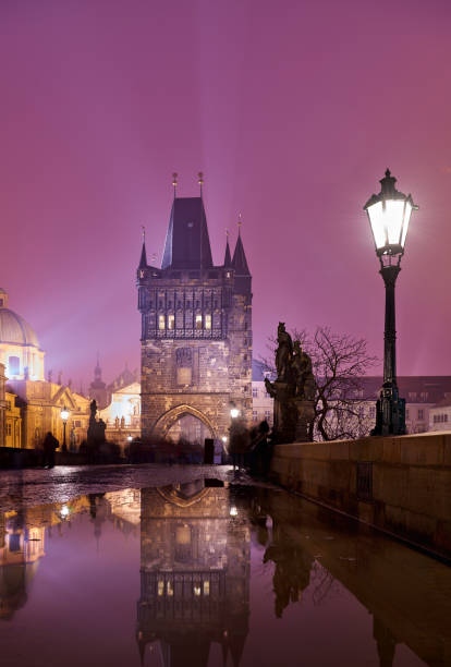 Charles bridge at night in dramatic sky, Prague, Czech Republic.