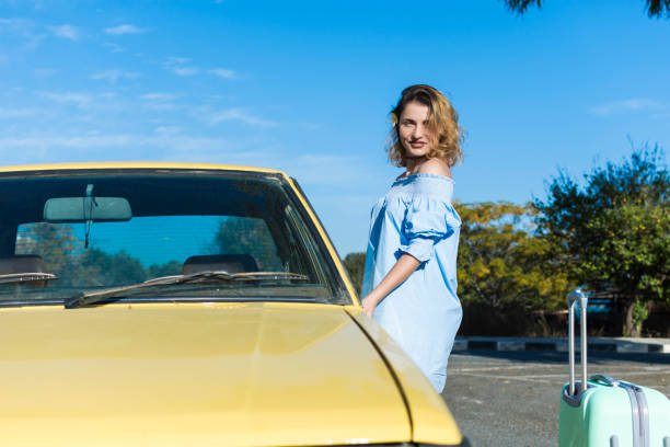 istock Blond woman and yellow car 904513600