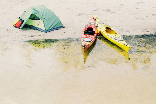 istock Rafting on kayaks. A tent camp stands on the river bank. 904515090