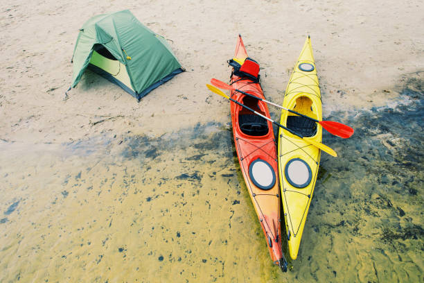 istock Rafting on kayaks. A tent camp stands on the river bank. 904515154