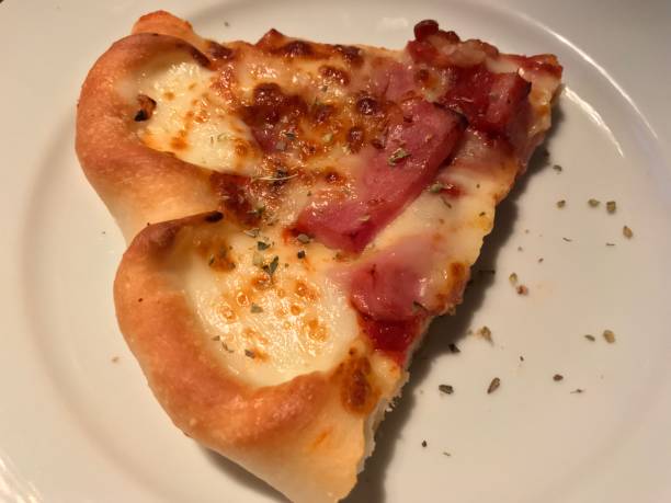 istock A piece of pizza in white dish 904518574