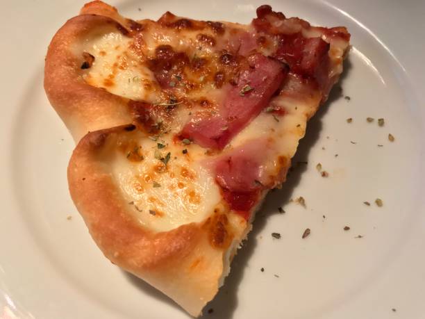 istock A piece of pizza in white dish 904518618