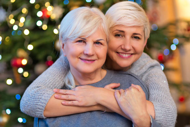 istock Mother and daughter by Christmas tree 904518748