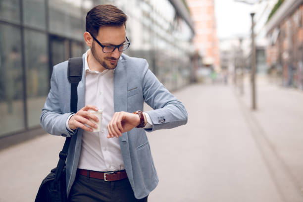 istock Businessman checking the time on his wristwatch 904519614