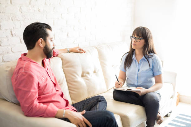istock Psychologist talking with depressed man in the office 904519970