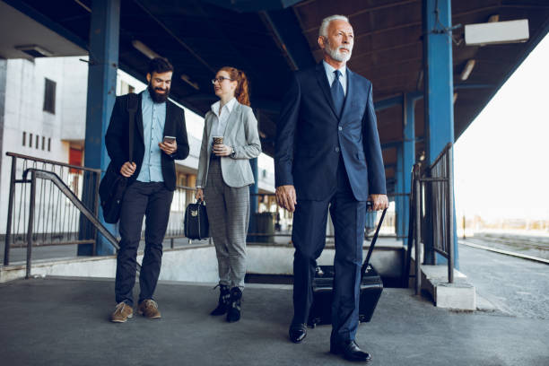 istock Business people with luggage at train station. 904522444