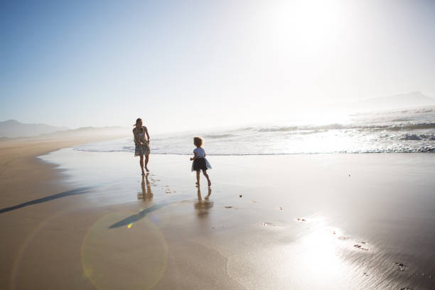 istock Mother with her daughter at the beach 904526866