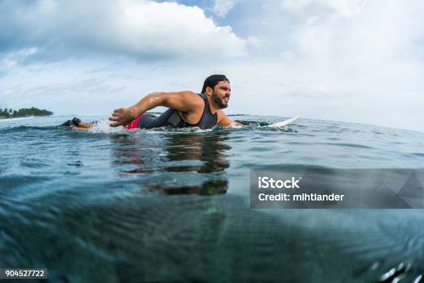 Muscular Surfer Paddling In The Ocean Stock Photo - Download Image Now - Active Lifestyle, Adult, Adults Only