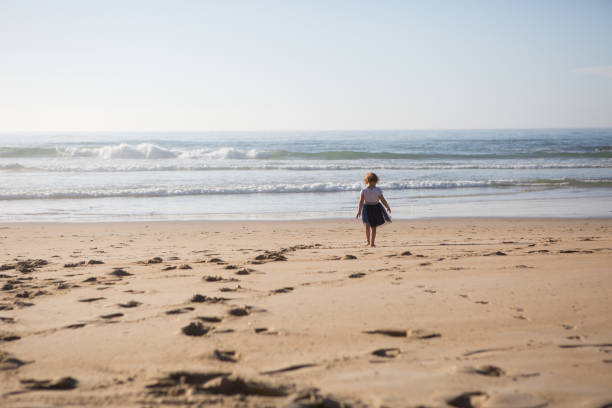 istock Young girl wondering on the beach 904527864