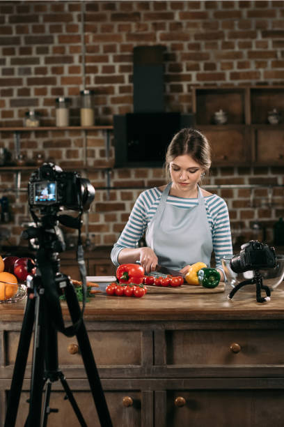 young beautiful food blogger cutting cherry tomatoes