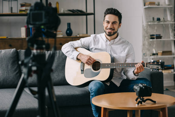 istock happy music blogger playing acoustic guitar 904531228