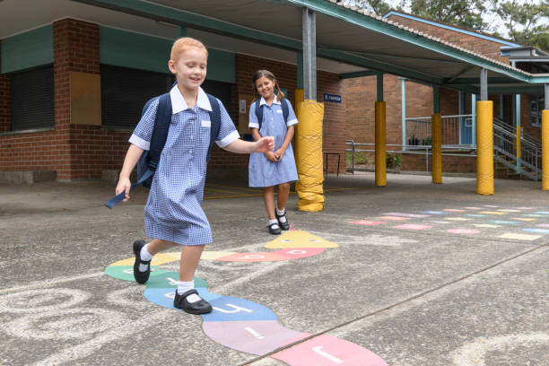 istock Two primary school girls playing outside in playground 904531422