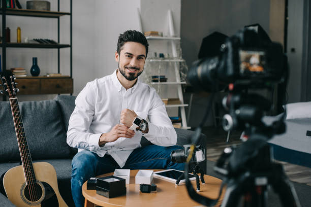 istock smiling technology blogger putting on new smart watch 904532620