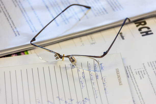 istock Glasses on stock exchange papers 904532800