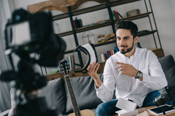 istock handsome technology blogger recording new vlog about virtual reality headset 904535158