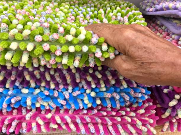 Man picking green carpet from carpet pile Carpet texture background rag picker stock pictures, royalty-free photos & images