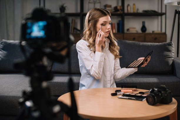 istock beauty blogger applying eyeshadow in front of camera 904540620