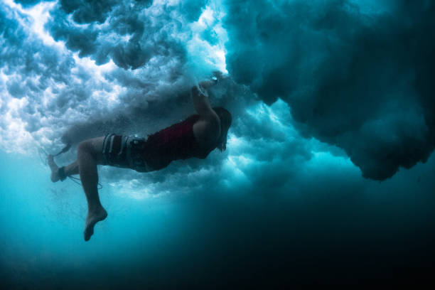 istock Underwater view of the surfer performing action named Turtle Rol 904544238