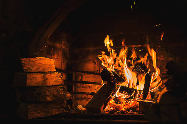 istock Burning fire in open fireplace with wooden fuel (firewood) 904554120