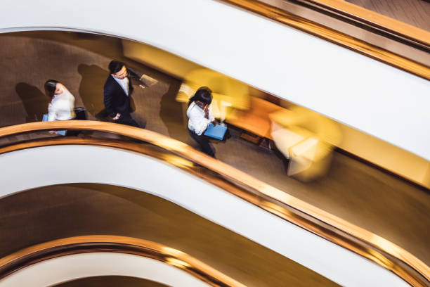 Motion blur of people on a contemporary spiral staircase.