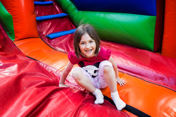 girl on jumping castle - inflatable child playground leisure games imagens e fotografias de stock