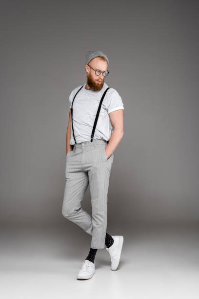 istock man in suspenders standing with hands in pockets 904557788