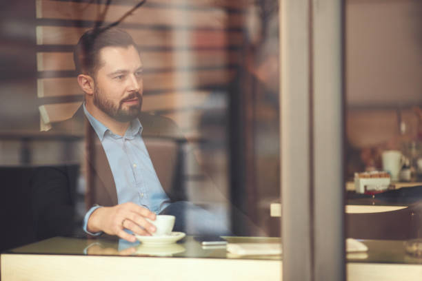 istock Businessman sitting in cafe. 904557912