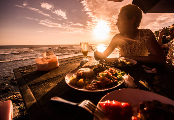 Blondie woman eating lunch in beach restaurant.