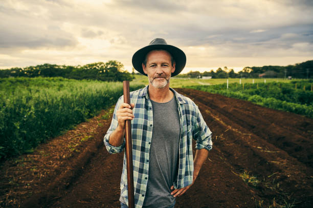 This farm is my pride and joy Cropped portrait of a handsome male farmer working on his farm Farmer stock pictures, royalty-free photos & images